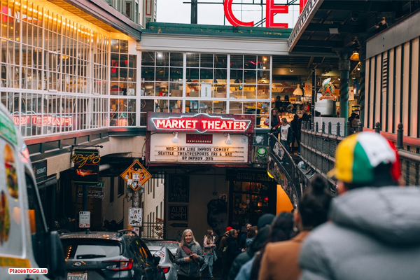 Seattle’s coffee culture – A barista pouring coffee with the Pike Place Market in the background.
