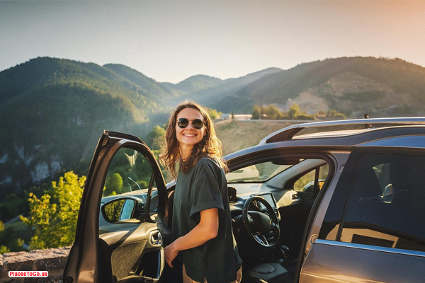 solo vs group road trips – woman on solo USA road trip at sunset